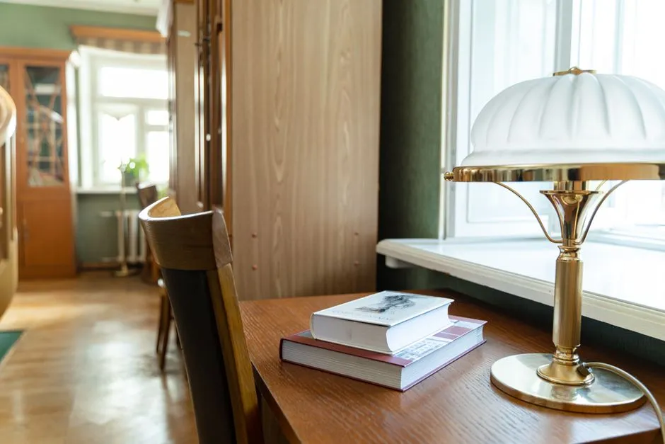 Reading room desk with an open reference volume and a notepad of handwritten dates