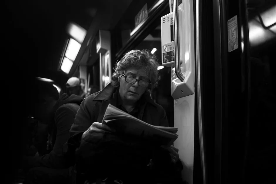 Commuter on a train reading a short email on a phone