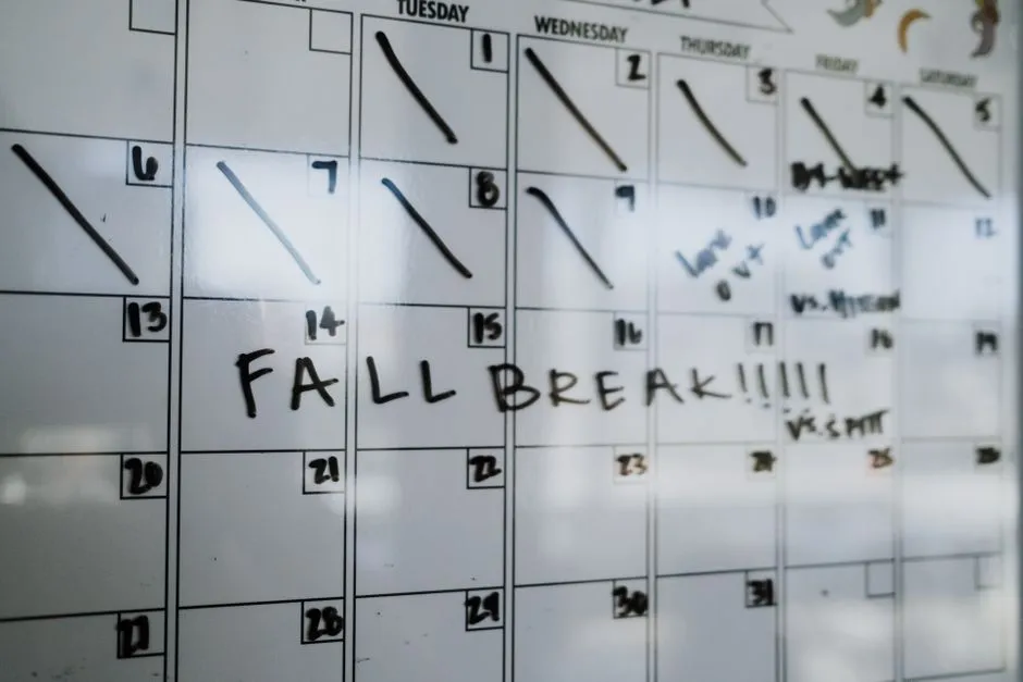 Teacher at a whiteboard with a calendar date written across the top